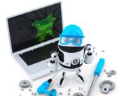 A robot is sitting next to a laptop.